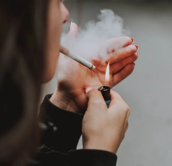 person lighting a cigarette