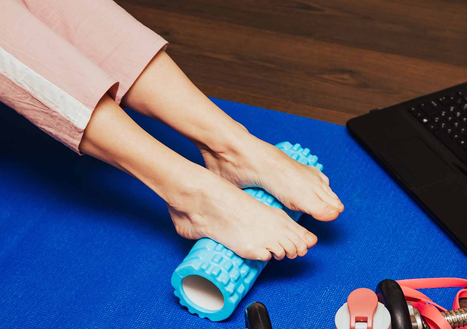 two feet on a rolling massage tube